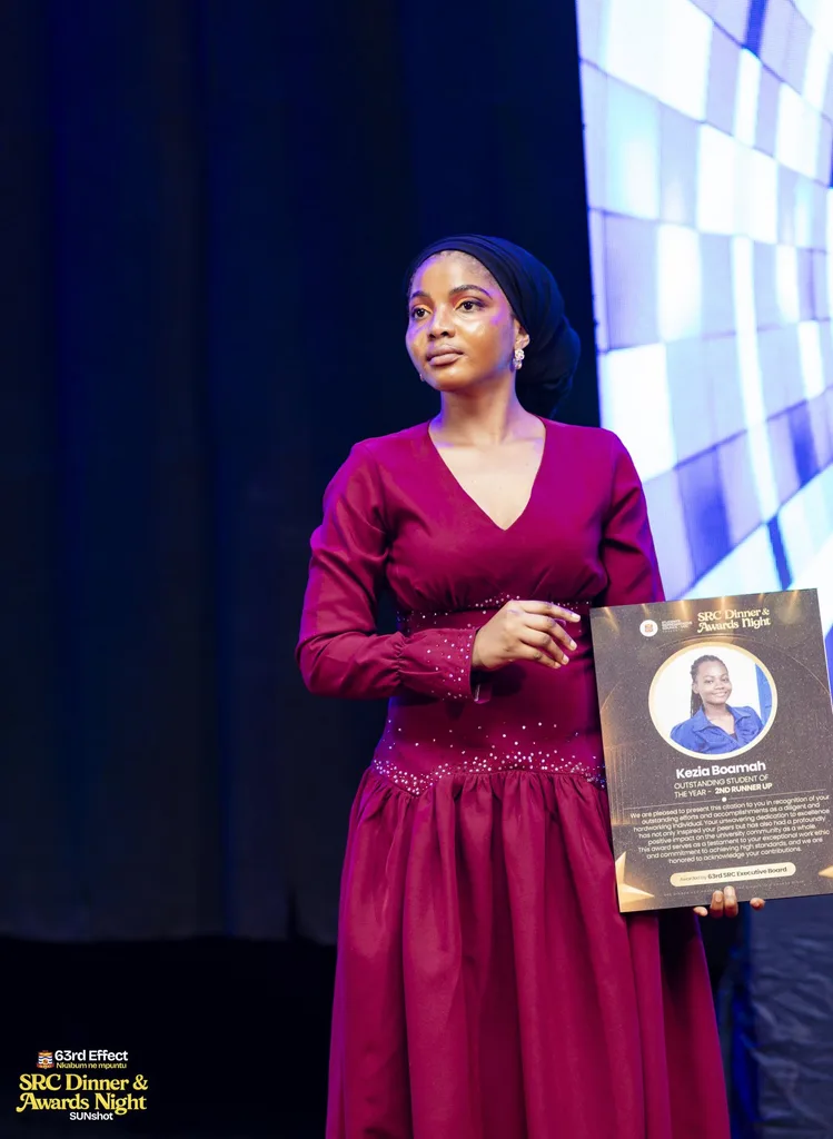 Recipient displaying a framed award